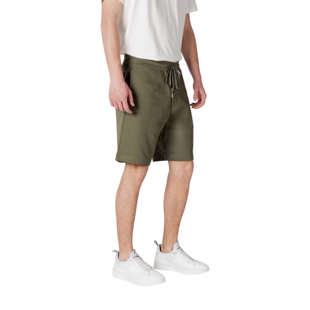 Model wearing Replay Green Cotton Bermuda Shorts with elastic waistband and drawstring, perfect for casual wear.