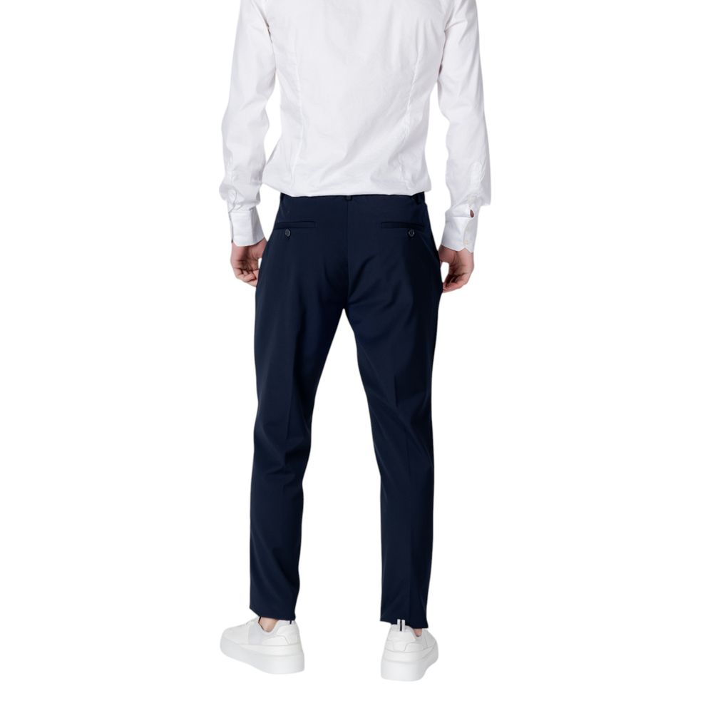 Back view of Antony Morato Blue Polyester Dress Pants with regular fit, paired with white shirt and sneakers.
