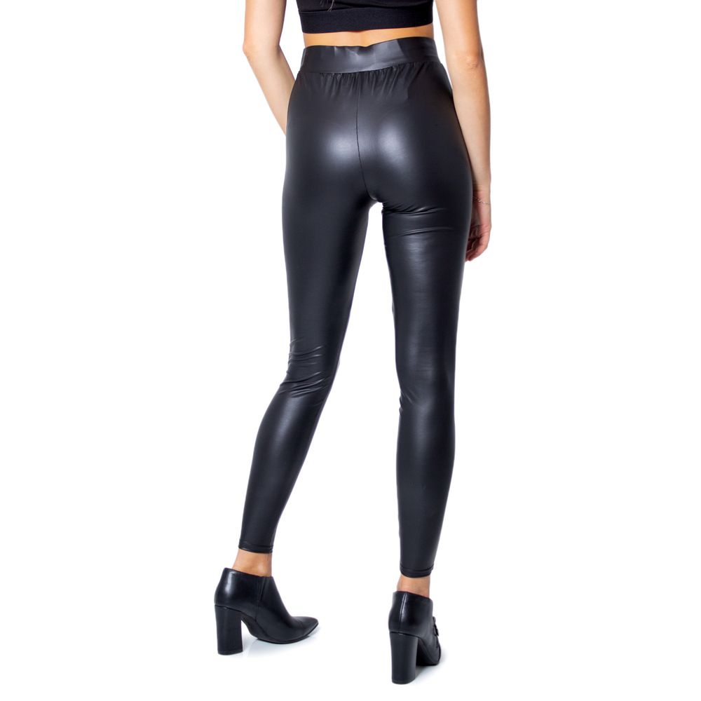 Woman wearing Only Black Polyester Leggings with glossy finish, side view, high heel shoes, showcasing curve-fitting style.