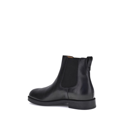 Side view of Tod's Black Calf Leather Bos Taurus Chelsea Boots showcasing round toe and elastic inserts for style and comfort.