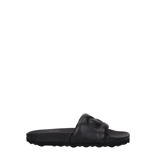 Off-White Black Leather Slippers featuring rubber sole and front logo, designed in sleek black leather, casual style with low, flat heel.