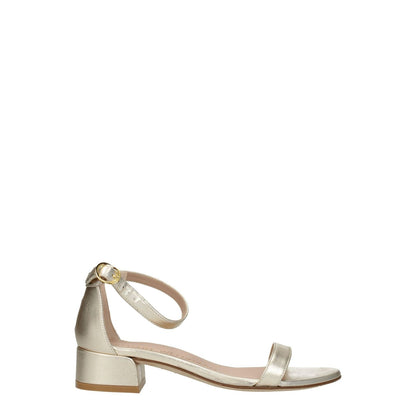 Stuart Weitzman Gold Leather Flat Sandals with buckle closure and mid heels, open toe style, made of metallic platinum leather.
