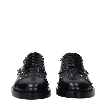 Valentino Garavani Black Leather Oxfords And Derbies with studs, lace up closure, round toe, mid heels, and leather sole, perfect for casual style.