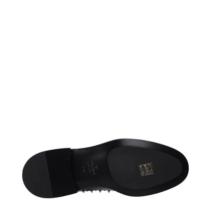 Sole view of Valentino Garavani Black Leather Oxfords And Derbies with black leather outsole, midsized heel, and stud detailing.