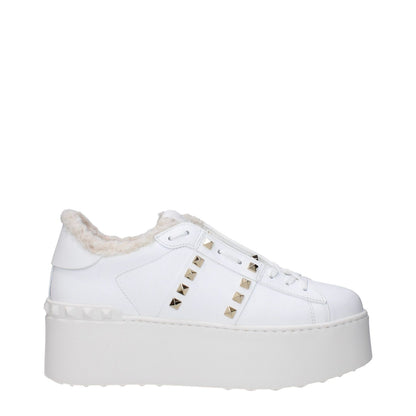 Valentino Garavani White Leather Platform Sneakers with studs and fur lining, casual lace-up with rubber sole and wedge heel.