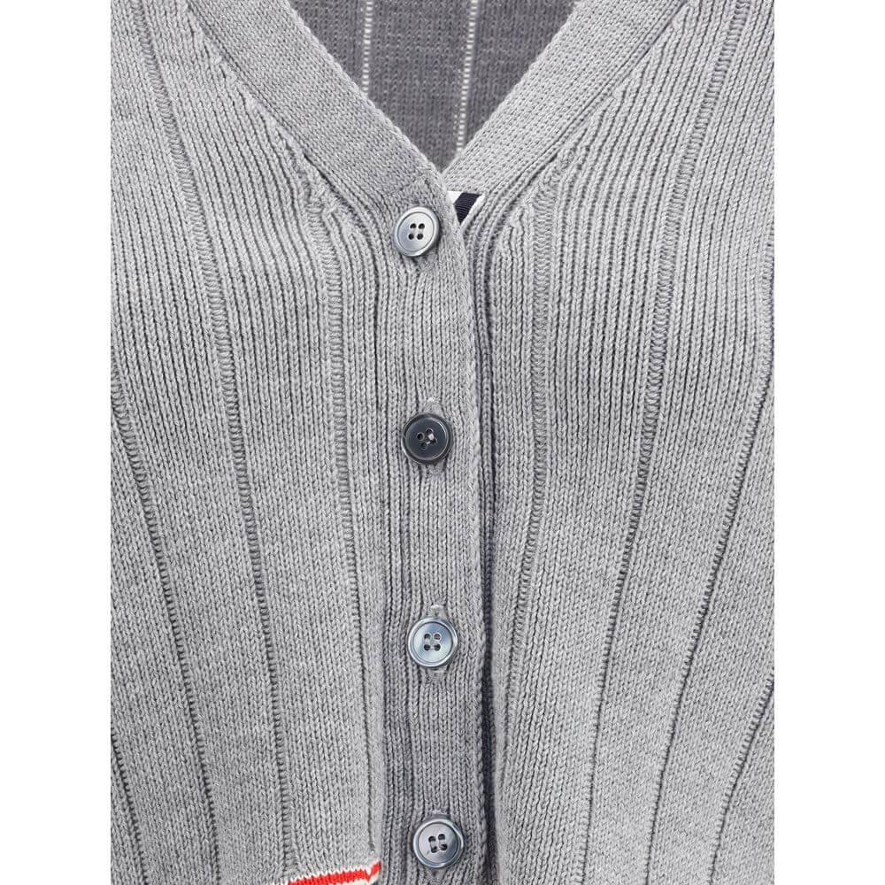 Thom Browne Gray Fleece Wool Cardigan with ribbed design, V-neck, button closure and iconic colored bands. Elegant and contemporary style.