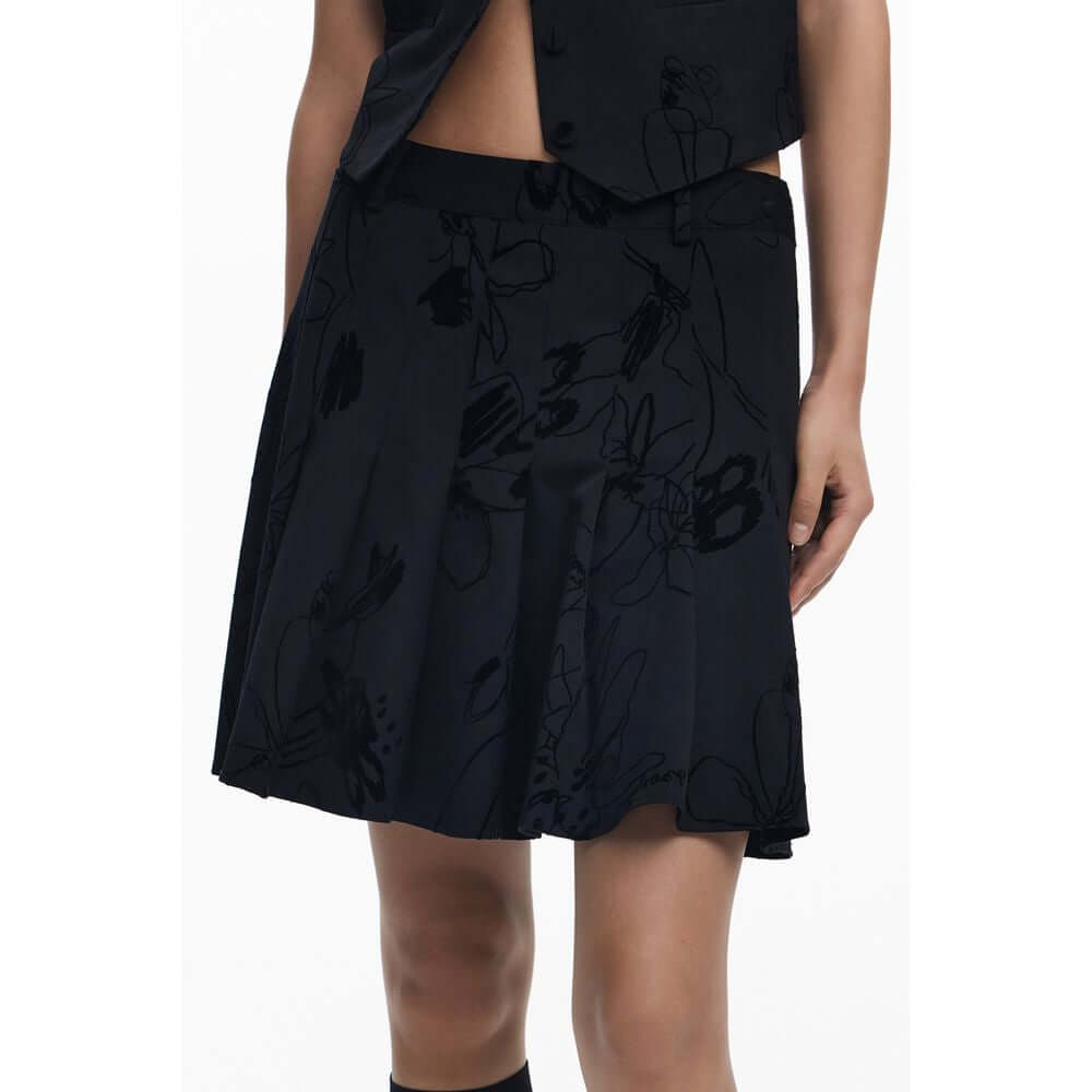 Desigual Black Polyester Women Skirt with bold flock design, sassy side zipper, and contrasting details on a model's lower half.