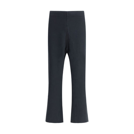 Margiela Black Cotton Casual Pants with raw-cut hems and elasticated waistband, showcasing urban elegance and creative design.