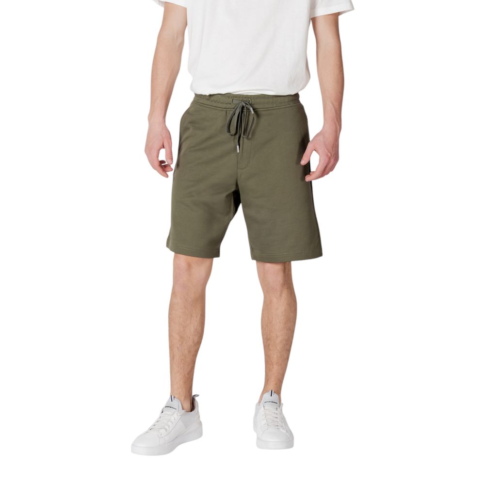 Man wearing Replay Green Cotton Bermuda Shorts with elastic waistband and drawstring for a casual, stylish summer look.