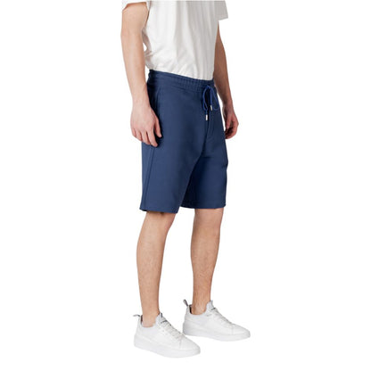 Man wearing Replay Blue Cotton Bermuda Shorts with sneakers and white t-shirt, focusing on comfort and style for warm weather.