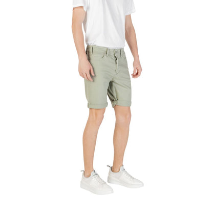 Man wearing Replay Green Cotton Bermuda Shorts with a white t-shirt and sneakers, showcasing a casual summer style.