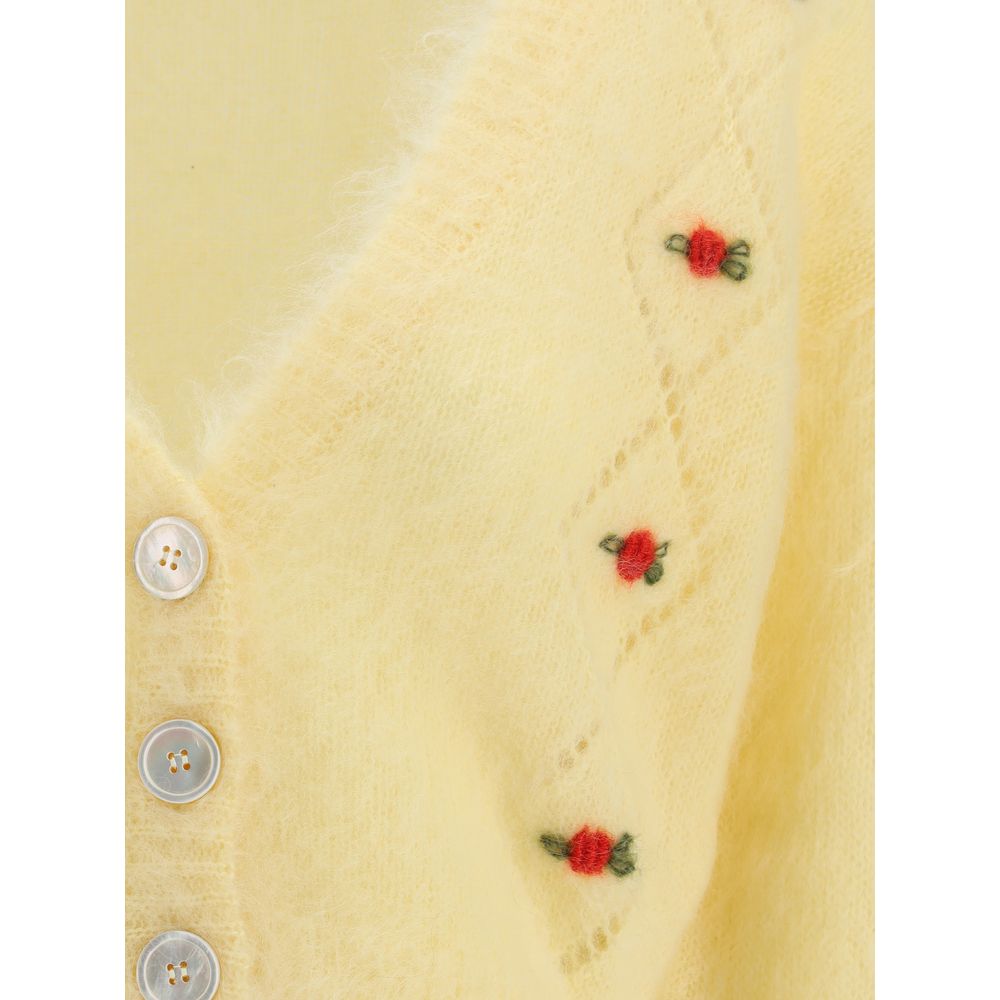 Close-up of Alessandra Rich Yellow Mohair Cardigan featuring floral embroidery, button closure, and delicate perforated details.