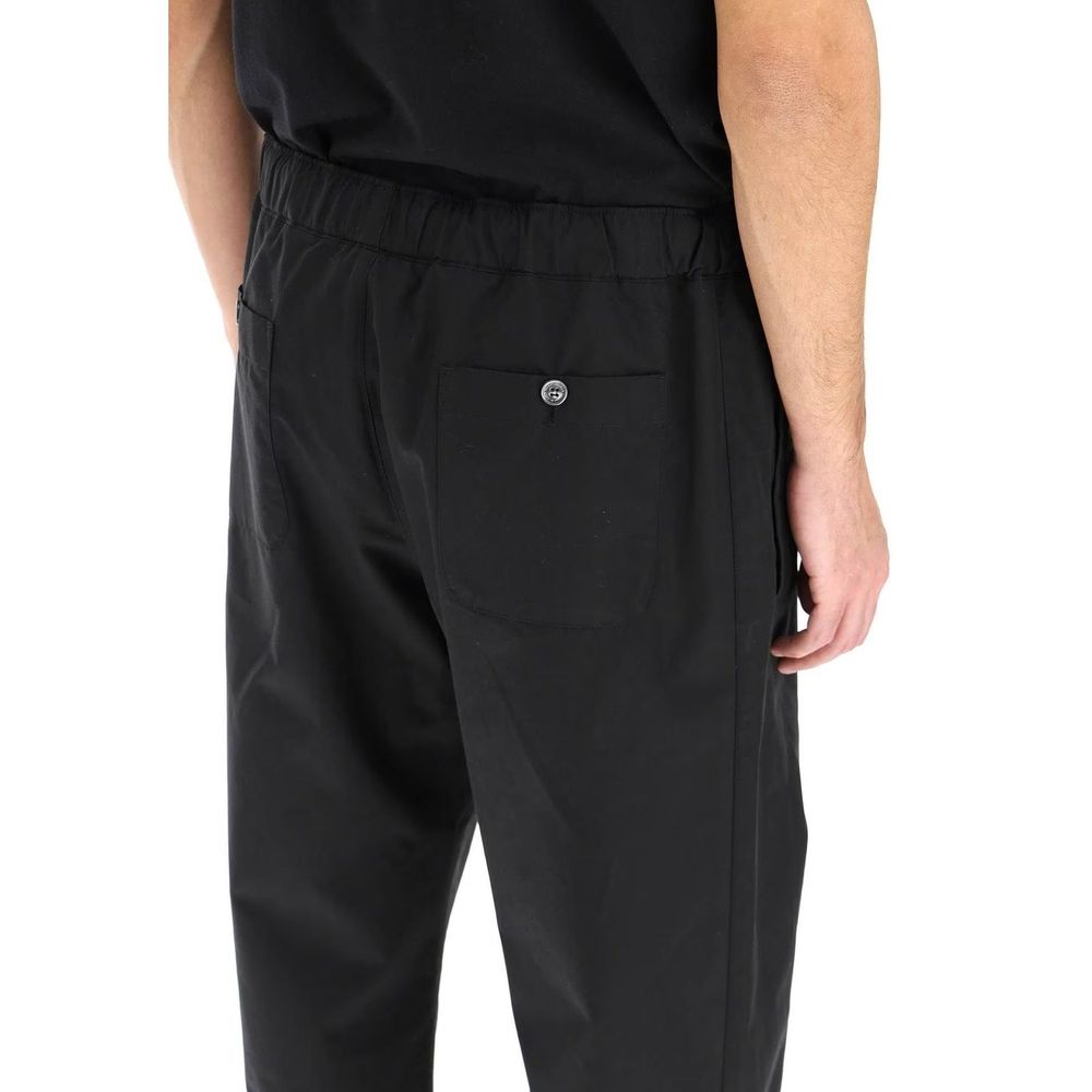 Back view of Alexander McQueen Black Cotton Casual Pants with elastic waist and back pocket detailing, perfect for casual wear.