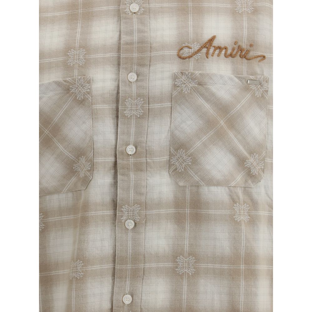 Amiri Beige Cotton Pattern Shirt featuring check flannel design, embroidered logo, and raw-cut hem for a contemporary look.