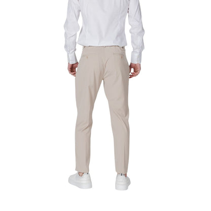 Back view of Antony Morato Beige Polyester Pant with regular fit and welt back pockets, worn by a model in white sneakers.