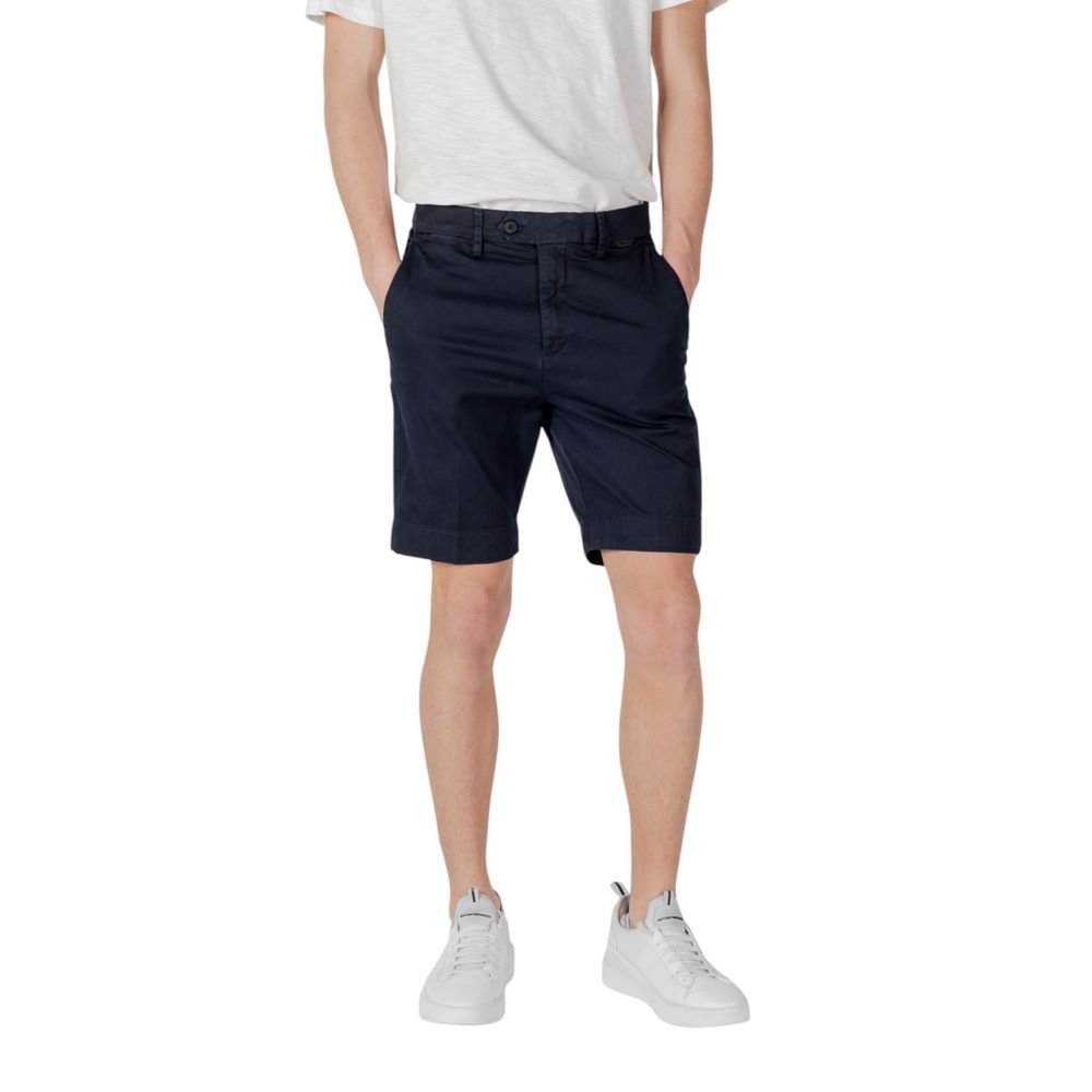 Man wearing Antony Morato Blue Cotton Bermuda Shorts showcasing slim fit design with logoed rubber flag, ideal for casual summer occasions.