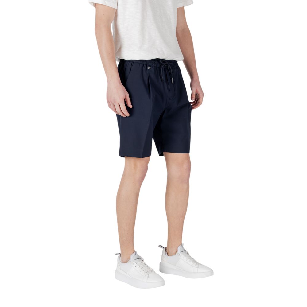 Man wearing Antony Morato Blue Polyester Bermuda Shorts paired with a white t-shirt and white sneakers, side view.