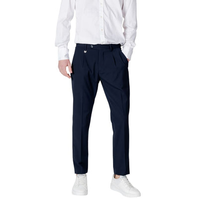 Model wearing Antony Morato Blue Polyester Dress Pants with white shirt and sneakers, showcasing regular fit and classic pleated design.