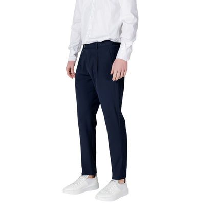 Man wearing Antony Morato Blue Polyester Dress Pants with regular fit and front pleats, styled with white shirt and sneakers.