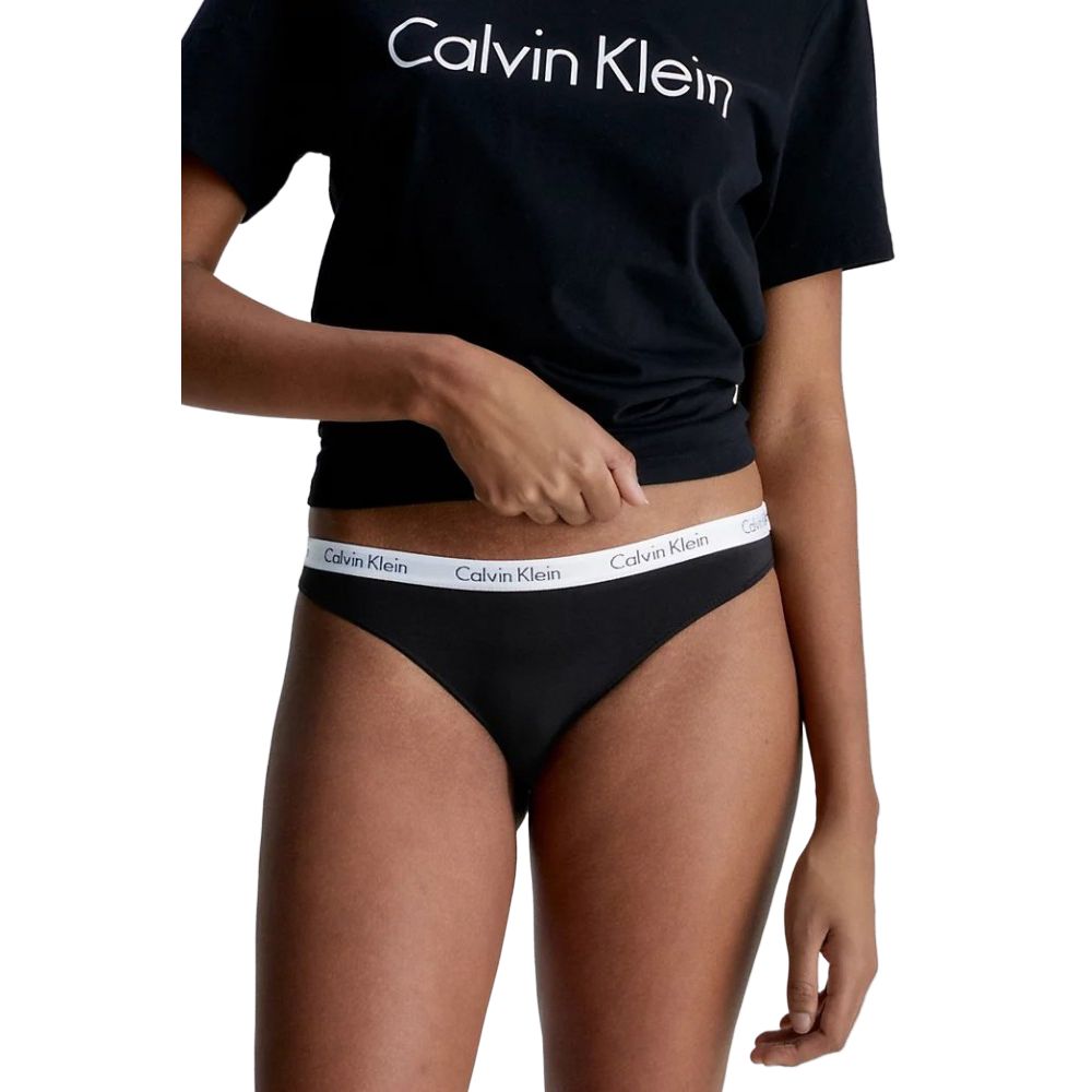 Woman wearing Calvin Klein Underwear Black Cotton Panty and black t-shirt, showcasing stylish design and comfortable fit.
