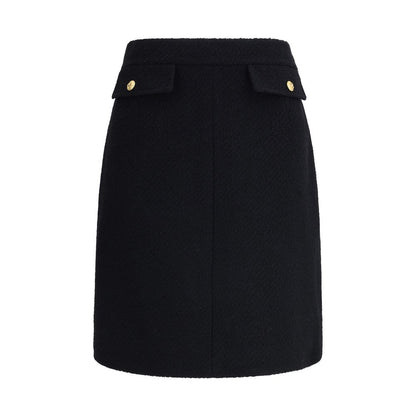 Chloé Black Wool Midi Skirt with front flap pockets and gold-tone buttons, crafted from bouclé wool for a structured fit.