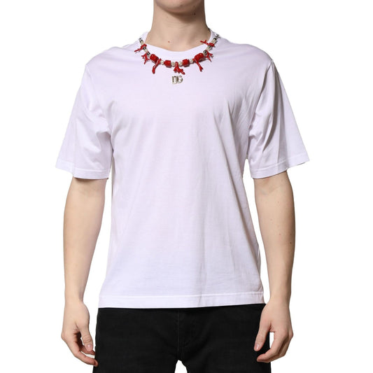 Model wearing Dolce & Gabbana White Embellished Cotton Crew Neck T-shirt with logo details, front view showing embellishments.