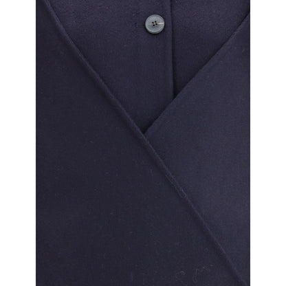 Close-up of Dynamis Studio Blue Wool Coat showing button detail and wool texture.