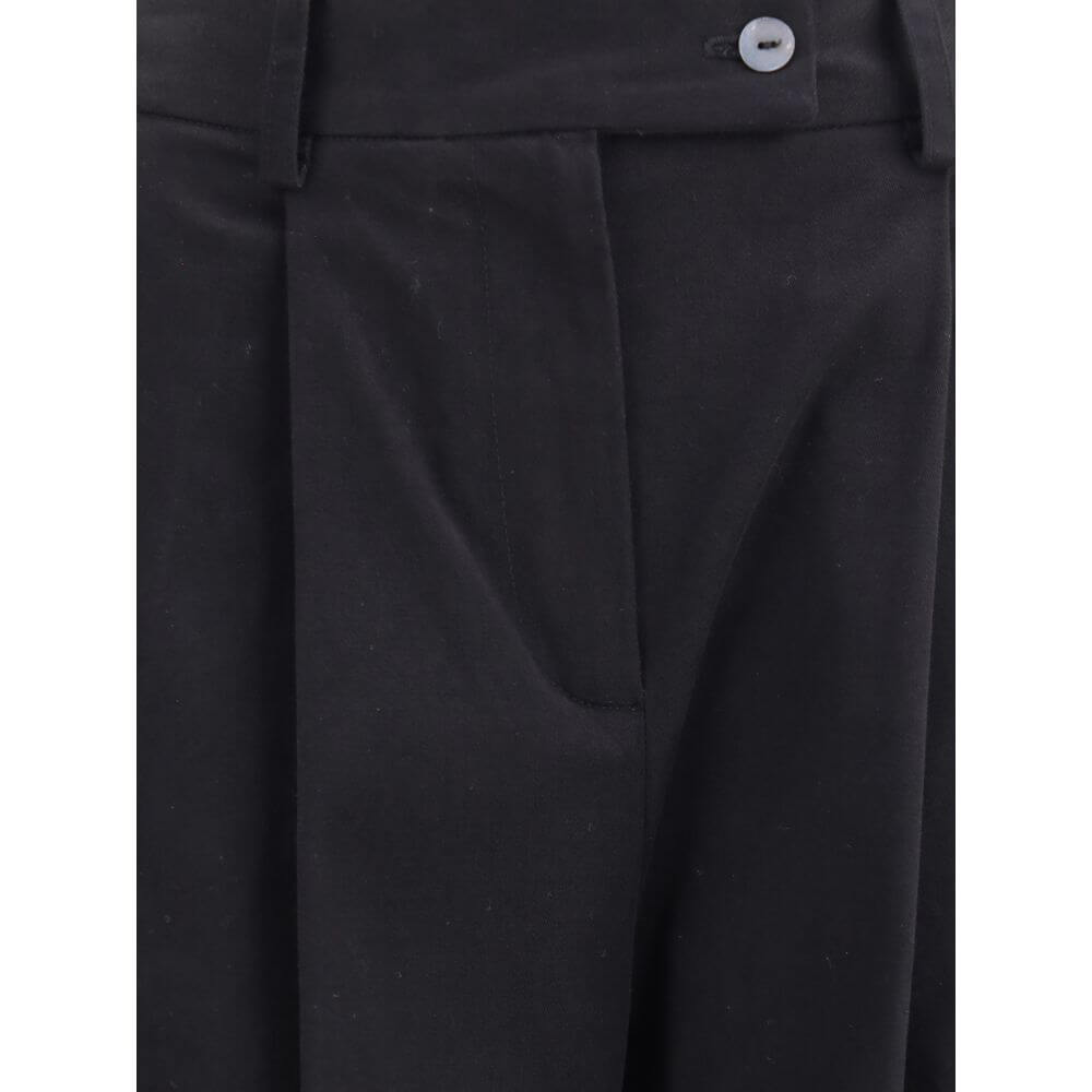 Close-up of Ella Black Cotton Casual Pants with front pleats, button closure, and wide leg design.