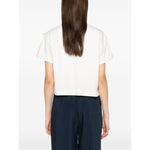 Back view of model wearing white Emporio Armani T-shirt with fringes, short sleeves, crew neck, and rear button fastening.