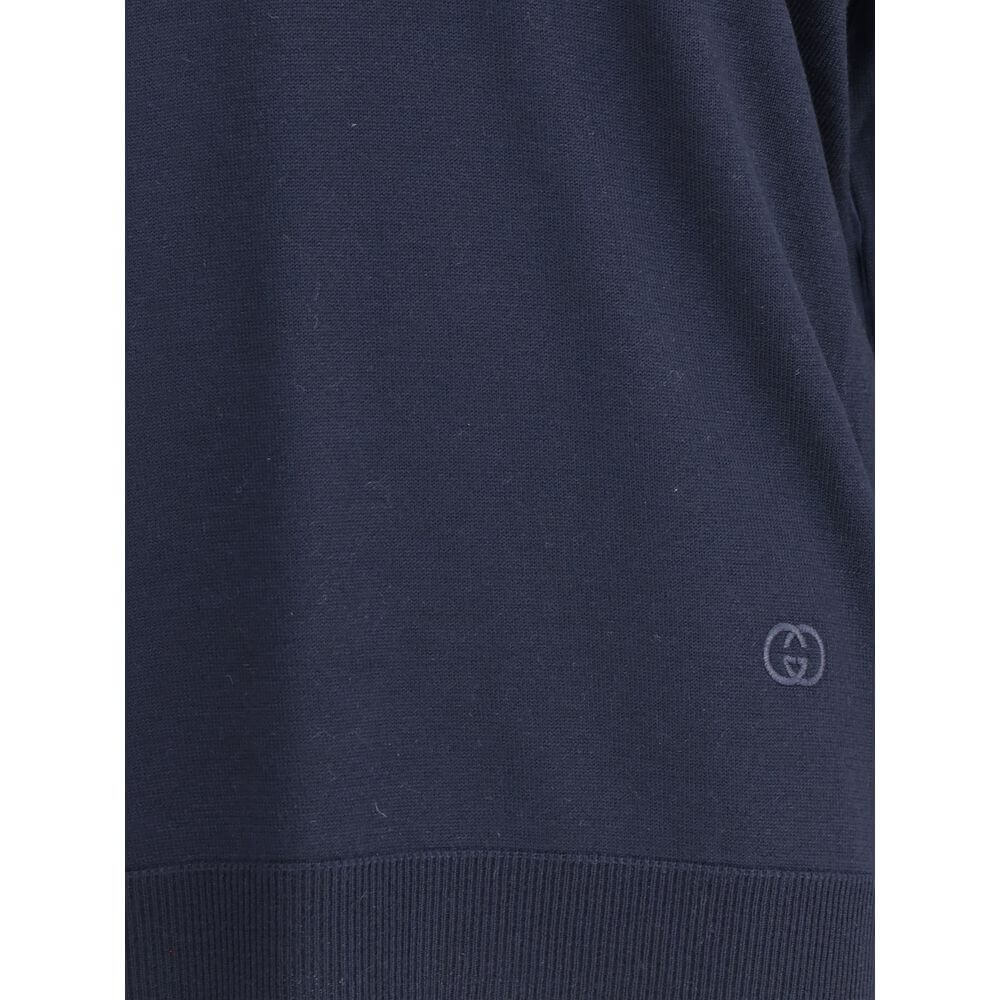 Close-up of Gucci Blue Wool Sweatshirt showing tone-on-tone embroidered logo, 100% wool fabric, and ribbed hem from AW25 collection.