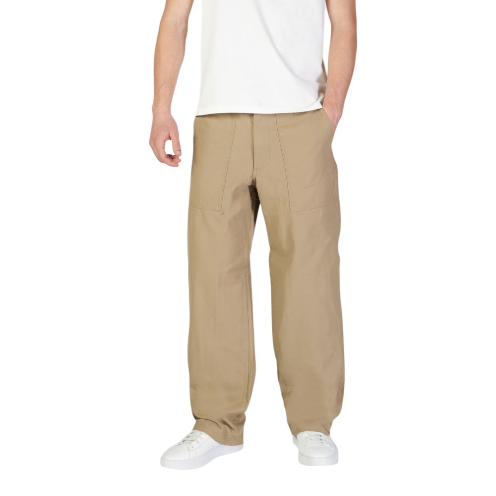 Man wearing Jack Jones Beige Cotton Casual Pants with front patch pockets and white sneakers