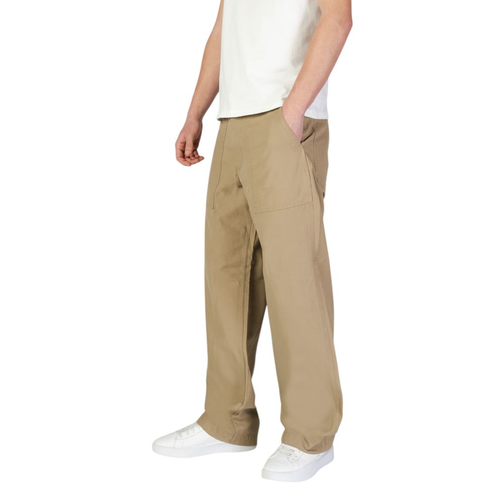 Man wearing Jack Jones Beige Cotton Casual Pants with front patch pockets and relaxed silhouette, perfect for modern urban look.