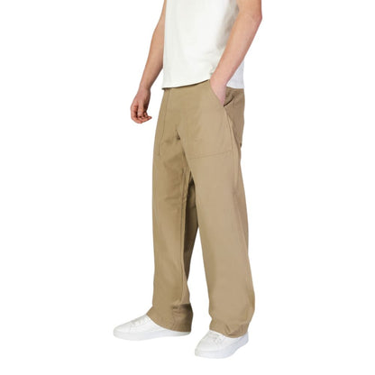 Man wearing Jack Jones Beige Cotton Casual Pants with front patch pockets and relaxed silhouette, perfect for modern urban look.