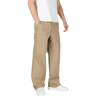 Jack Jones Beige Cotton Casual Pants with front patch pockets, worn by a man in white sneakers, displaying a regular fit for comfort.