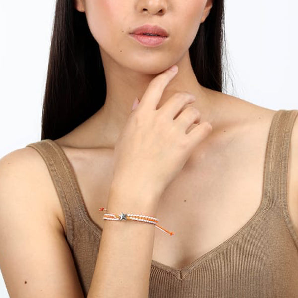 Woman wearing LA PETITE STORY JEWELRY Mod. LPS05ARR79 bracelet with casual top, showcasing elegant accessory style.