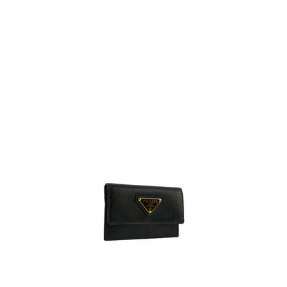 Prada Black Calfskin Cardholder with front logo plaque, two card slots, and flap top button closure, made of 100% calf leather.