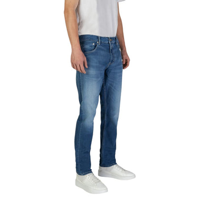 Man wearing Replay Blue Cotton Slim Fit Jeans showing front view with classic five-pocket design and tapered fit.