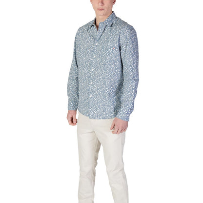 Model wearing Replay Light Blue Cotton Pattern Shirt with floral design, long-sleeve, button-down front, paired with white pants