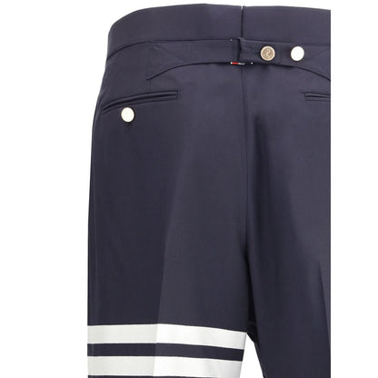 Close-up of Thom Browne Blue Wool Dress Pants with iconic bands and contrasting buttons.