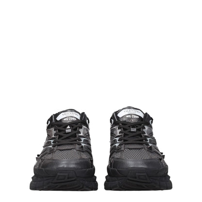 Valentino Garavani Black Fabric Athletic Sneakers with studs and logos, lace-up closure, rubber sole, mid heel, round toe.