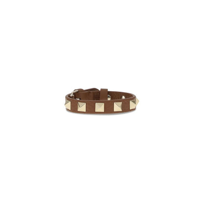 Valentino Garavani Brown Metal Bracelet with iconic leather Rockstuds, adjustable buckle closure, fashion accessory AW25 collection.