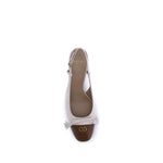 Top view of Valentino Garavani Valet Du Roi Pumps in two-tone leather with VLogo and tassel bow.