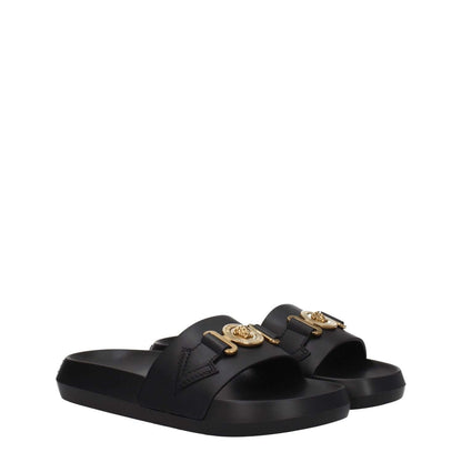 Versace Black Leather Slippers with gold front detail and back logo, casual open toe design, low flat heel, and rubber sole.
